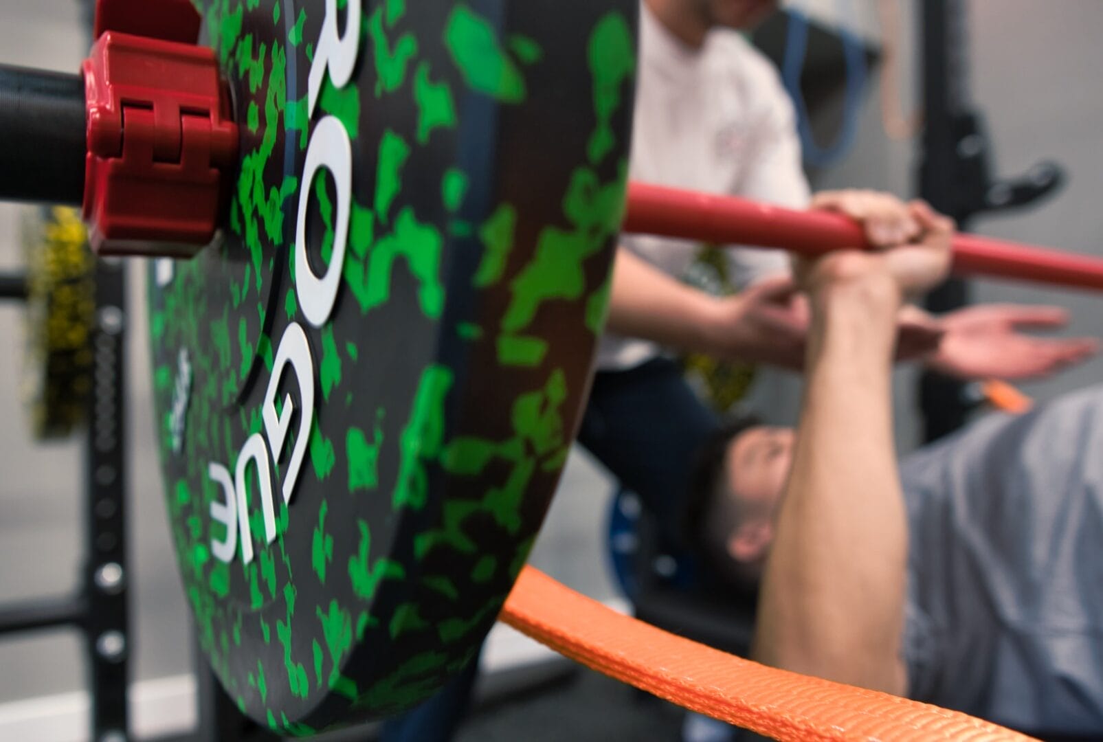 A personal training client bench pressing