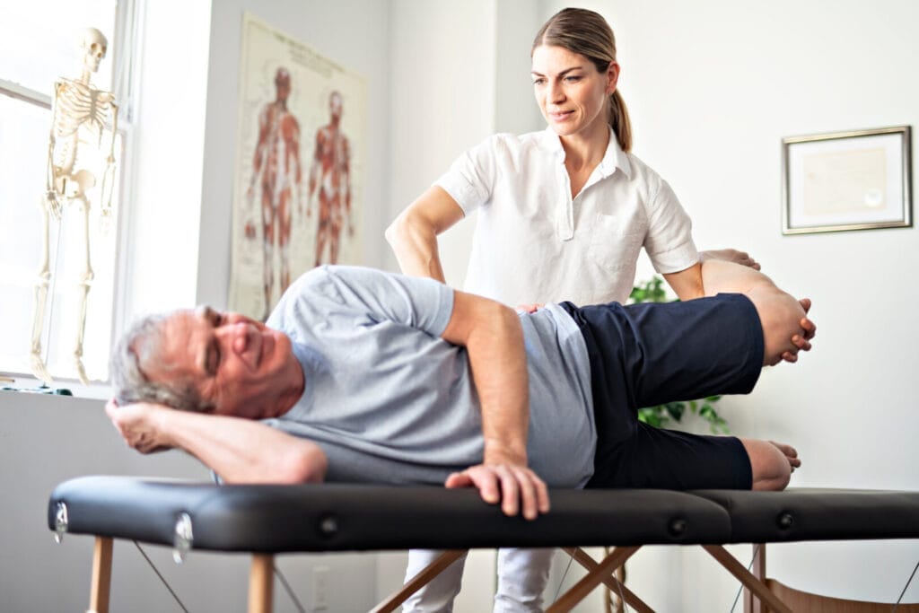 An Athletic Therapists treating a hip injury